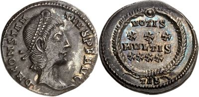 a silver coin with an image of a woman on it