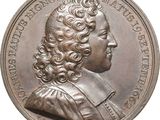 une vieille pièce d'argent sur laquelle figure le portrait d'un homme aux cheveux bouclés
