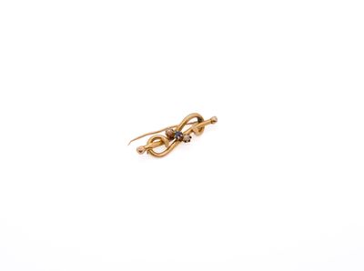 a close up of a gold earring on a white background