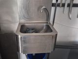 an image of a kitchen with a sink and a blue bucket