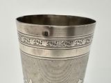 a silver cup that is sitting on a table