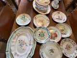 a wooden table with many plates and bowls on it