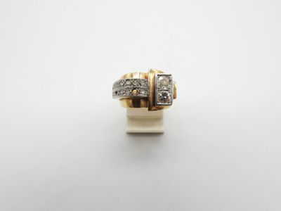 a gold and diamond ring on a white surface
