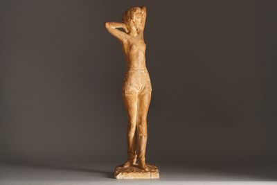 sculpture of a female nude torsoed figure on a gray background