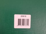 a close up of a green book with a barcode on it