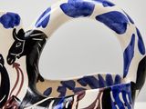 a blue and white vase with a horse on it