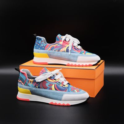 a pair of colorful sneakers on top of an orange box