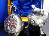 two silver objects in a blue box on a table