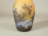 un petit vase avec un tableau posé sur une table