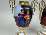 two vases that have pictures on them on them