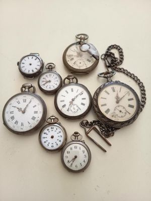 de nombreux modèles différents de montres de poche posés sur une table