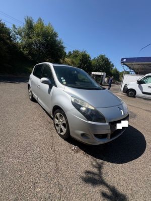 the silver car is parked on the side of the road