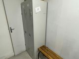 a metal locker and a wooden bench in a room