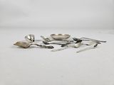 a group of silver spoons and spoon spoons on a white surface