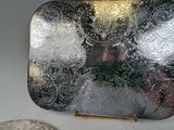 a silver purse sitting next to a coin on a table