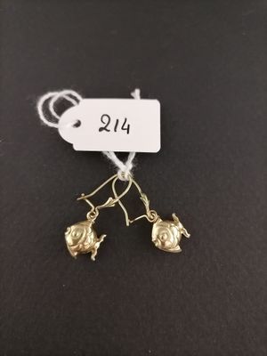 a pair of gold earrings with a small bird on them