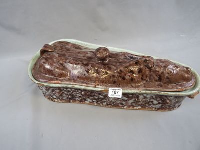 a brown and white cake in a green dish on a table