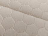 a close up view of a mattress with a white cover