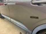 a close up of a car door with a sticker on it