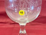 a glass that has a yellow sticker on it