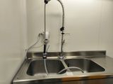 a kitchen sink with a faucet and a faucet attached to it
