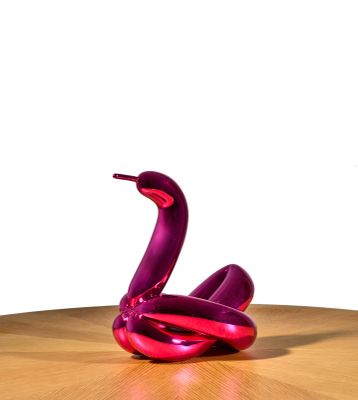 a purple sculpture of a snake on a wooden table
