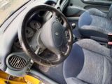 a steering wheel and dashboard of a small car