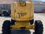 a yellow tractor that is parked in a parking lot