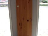 a wooden door in a room with a black mat on the floor