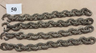 several strands of silver colored thread are on a table
