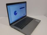 a laptop computer sitting on a table with a blue screen