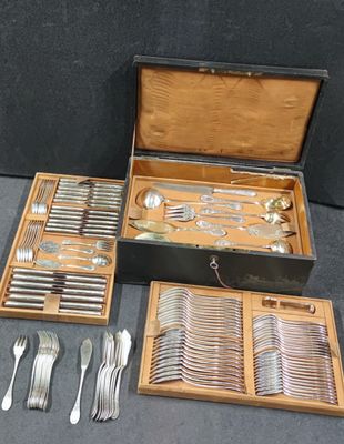 a lot of silverware in a wooden box on the floor