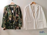 two jackets hanging on the wall next to each other