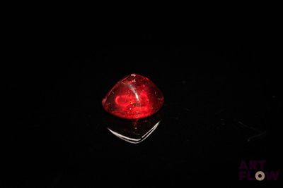 a close up of a red light on a black surface