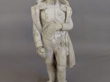 statue of a man with a hat and coat on a gray background