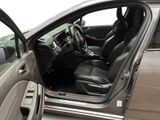 the interior of a car with the door open and the driver ' s seat down