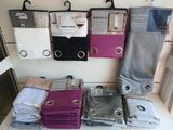 a lot of folded clothes on a shelf in a store