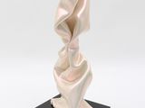 sculpture on black base on white background with white background