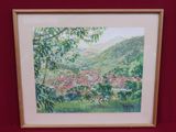 framed watercolor painting of a view of a village in the mountains