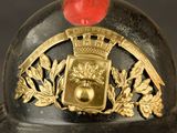 a close up of a helmet with a red apple on it