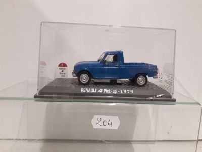 a blue truck in a glass case on a table