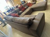 a large sectional couch in the middle of a living room