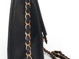 a black purse with a chain hanging from it ' s side