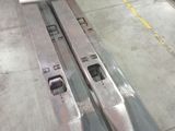 two skis that are sitting on a pallet in a warehouse