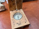 a wooden box with a compass on it on a table