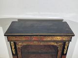 an antique black and gold painted fireplace with a marble top