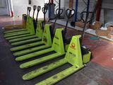 many forklifts lined up in a row in a warehouse