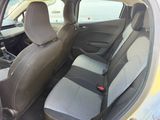 the back seats of a small car are empty in a parking lot