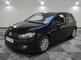 the black volkswagen golf is parked on a checkered tile floor