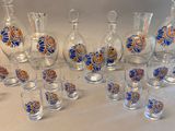 many glasses and vases that are sitting on a table